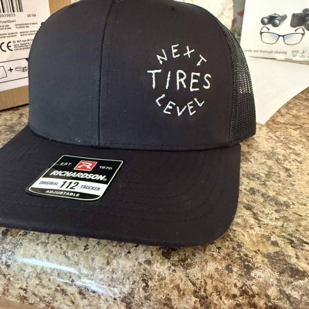 Custom embroidered black trucker hat with business logo - Flameingo Forge