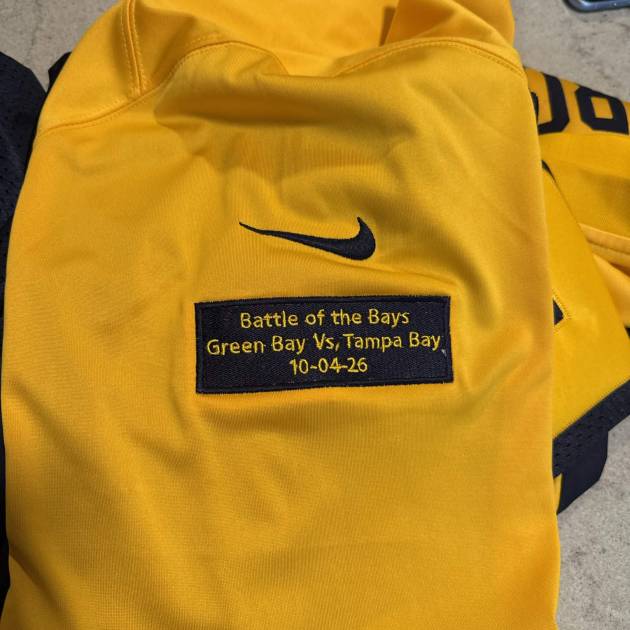 Custom embroidered commemorative patch on football jersey - Flameingo Forge
